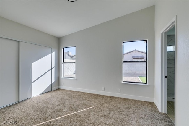 unfurnished bedroom with carpet flooring and a closet