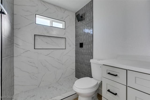 bathroom with toilet and tiled shower