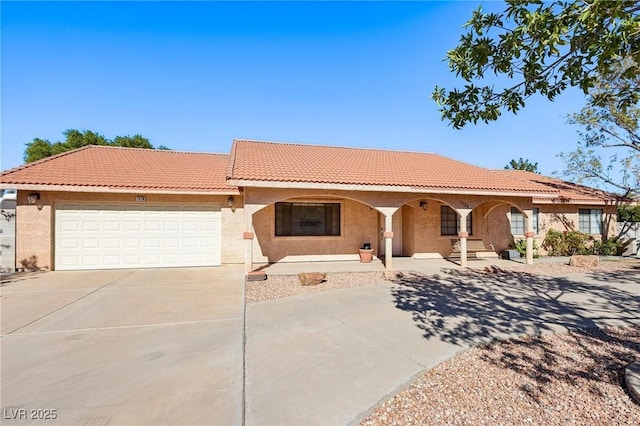 mediterranean / spanish home with a garage and covered porch