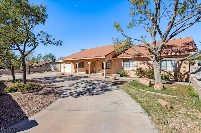 mediterranean / spanish-style home with a garage