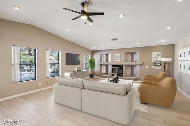 living room featuring lofted ceiling, light wood-type flooring, and ceiling fan