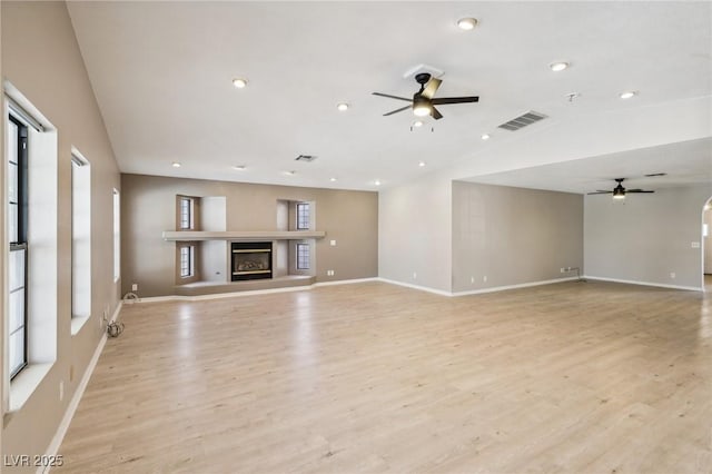 unfurnished living room featuring ceiling fan and light hardwood / wood-style floors