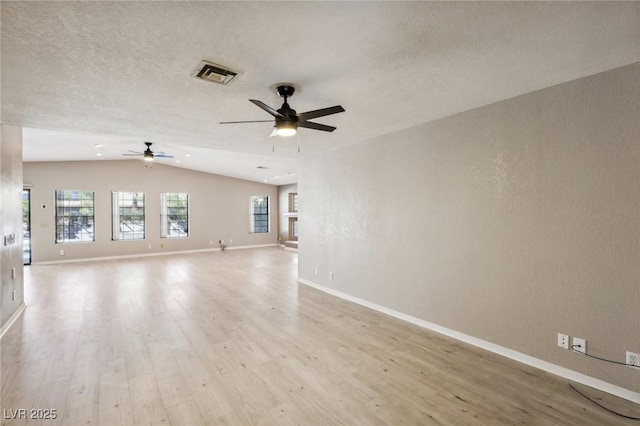 unfurnished room with vaulted ceiling, ceiling fan, and light hardwood / wood-style floors