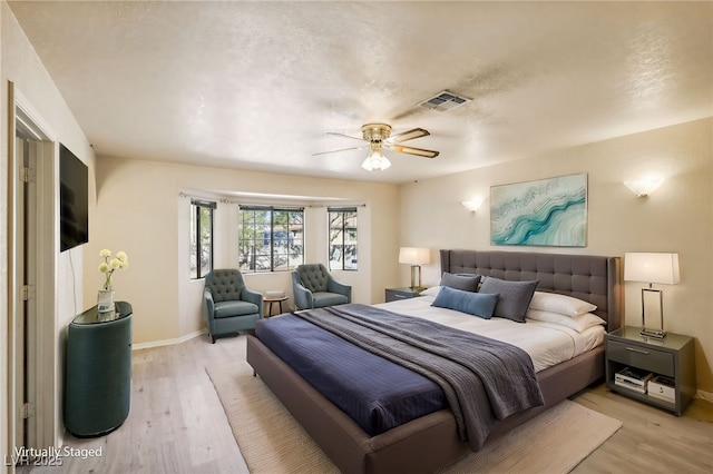 bedroom with light wood-type flooring and ceiling fan