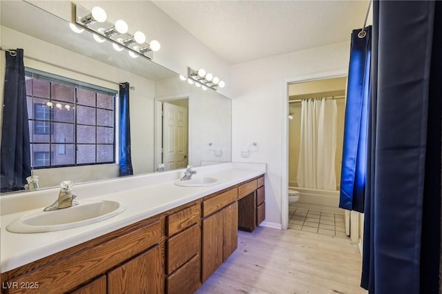 full bathroom with toilet, vanity, shower / bathtub combination with curtain, and hardwood / wood-style flooring