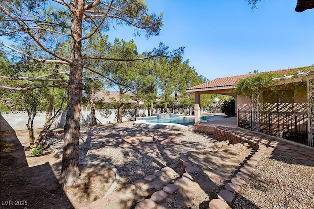 view of yard featuring a fenced in pool and a patio area