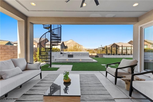 view of patio with an outdoor living space and ceiling fan