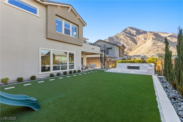 view of yard featuring a patio area and a mountain view