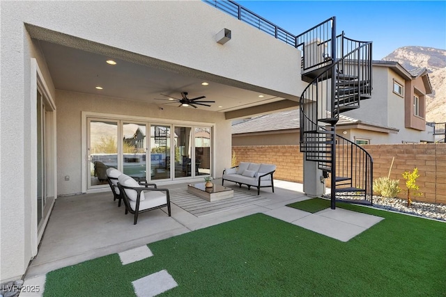 view of patio / terrace with a mountain view, ceiling fan, and an outdoor living space