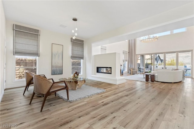 interior space featuring light wood-type flooring and a chandelier