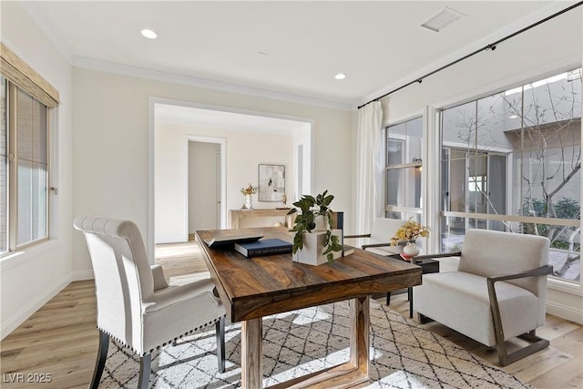 interior space with light hardwood / wood-style flooring and ornamental molding