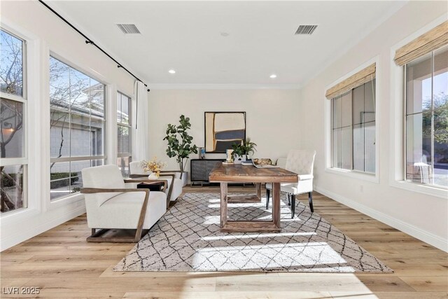 office space featuring light hardwood / wood-style flooring and crown molding