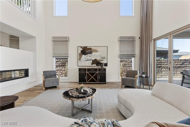 living room featuring hardwood / wood-style floors and a high ceiling