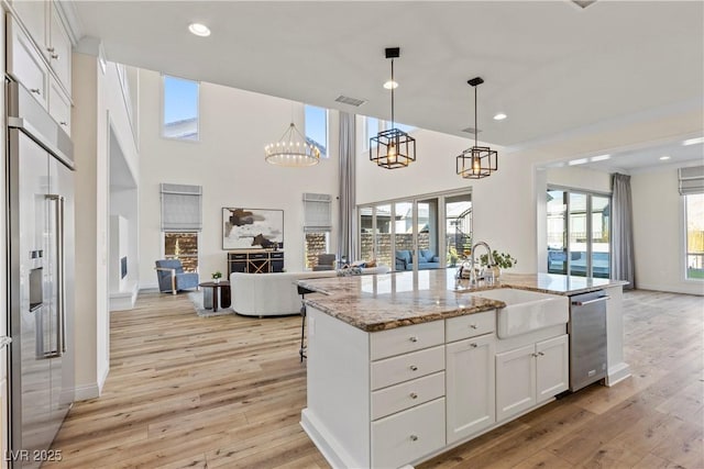 kitchen with white cabinetry, sink, a center island with sink, and appliances with stainless steel finishes