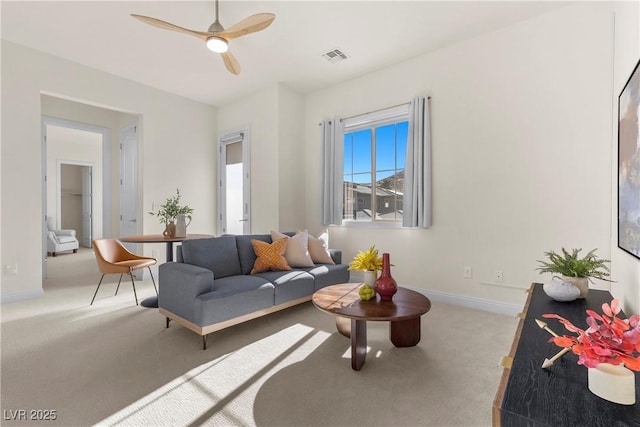 living room featuring light carpet and ceiling fan