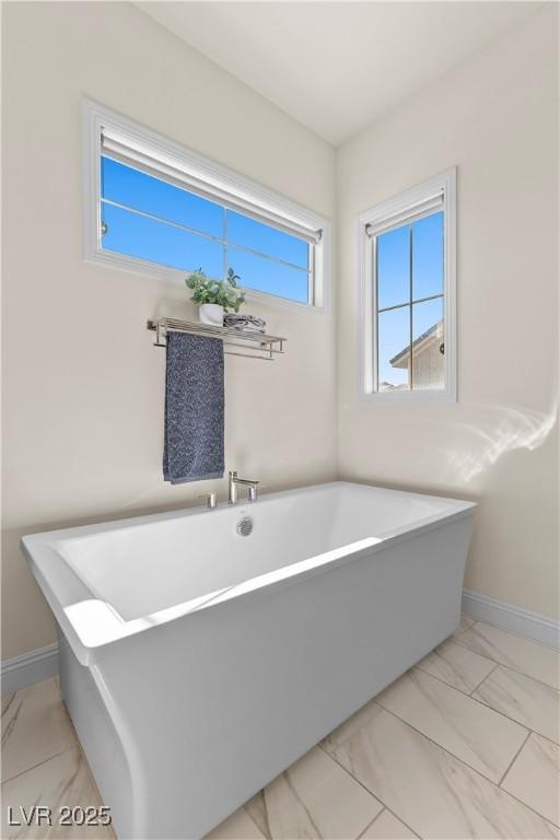 bathroom with a tub to relax in