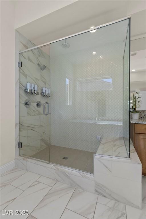 bathroom featuring a shower with shower door