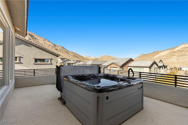 view of patio featuring a mountain view and a balcony