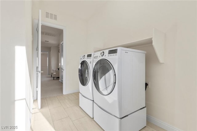 clothes washing area featuring washing machine and clothes dryer