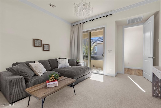 carpeted living room with an inviting chandelier