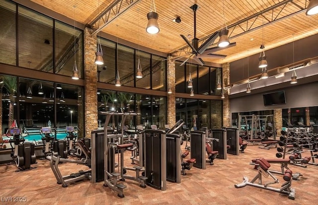 workout area with a towering ceiling and wooden ceiling