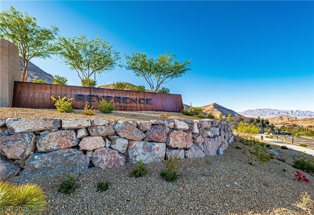 community sign with a mountain view