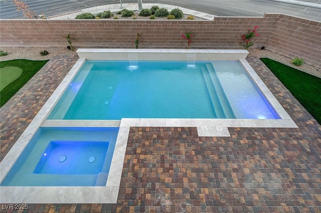 view of pool featuring an in ground hot tub and a fenced backyard