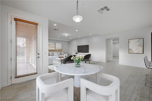 dining room featuring recessed lighting, visible vents, and light wood finished floors