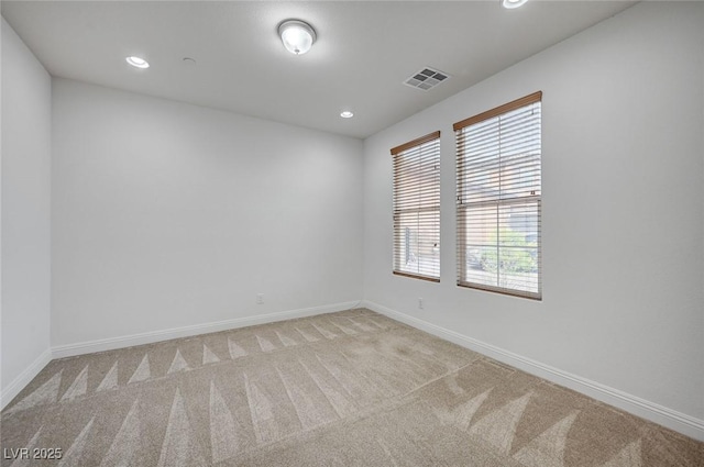 unfurnished room featuring recessed lighting, baseboards, visible vents, and light carpet