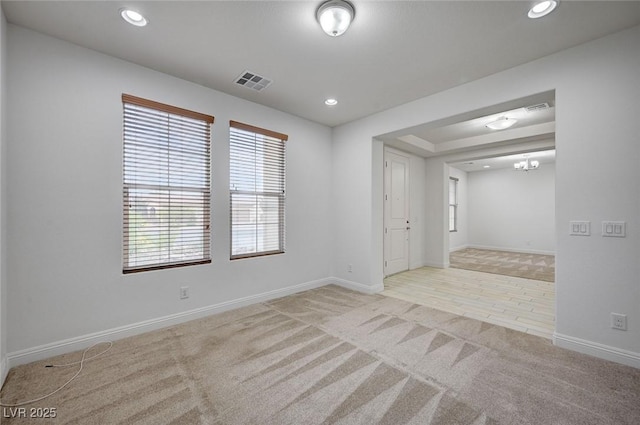 unfurnished room with recessed lighting, visible vents, baseboards, and carpet