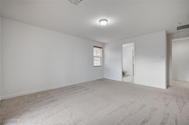 unfurnished room with visible vents, baseboards, and carpet floors