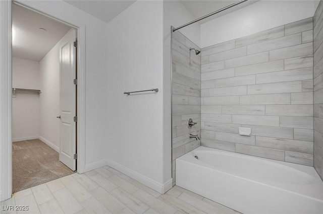 full bathroom with baseboards and washtub / shower combination