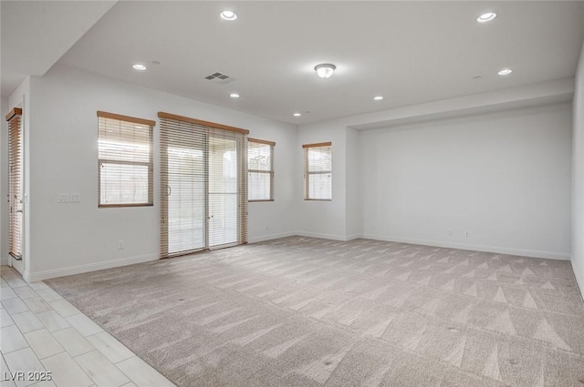 spare room featuring recessed lighting, visible vents, baseboards, and light colored carpet