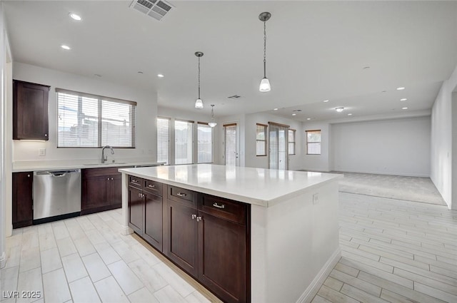 kitchen featuring a sink, visible vents, dishwasher, and a healthy amount of sunlight