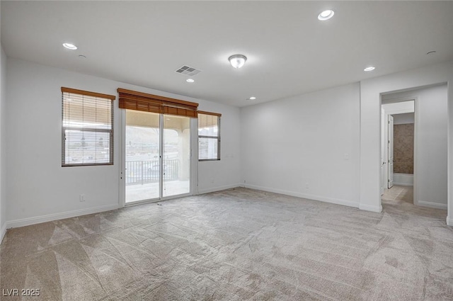 unfurnished room featuring recessed lighting, visible vents, and light colored carpet