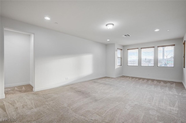 empty room with recessed lighting, visible vents, baseboards, and light colored carpet