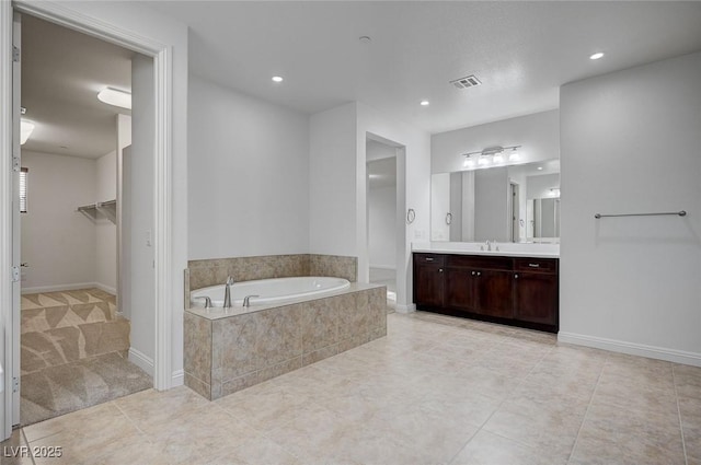 full bathroom with recessed lighting, visible vents, a garden tub, and vanity