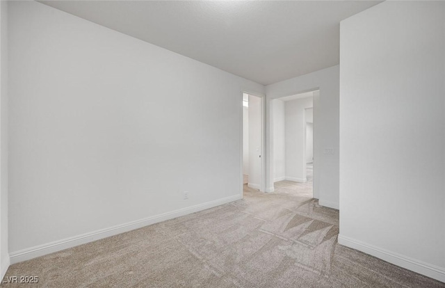 empty room with carpet and baseboards