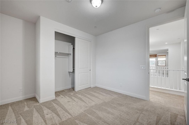 unfurnished bedroom featuring a closet, baseboards, and carpet