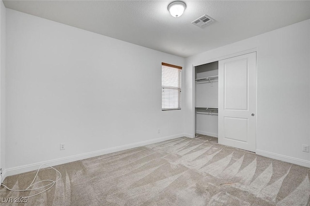 unfurnished bedroom featuring a closet, baseboards, and carpet floors