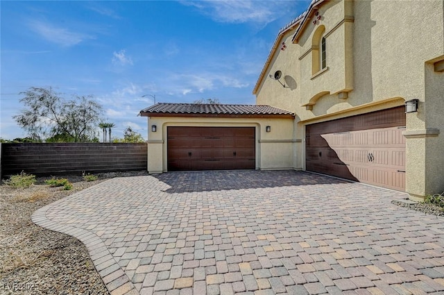 garage with driveway and fence