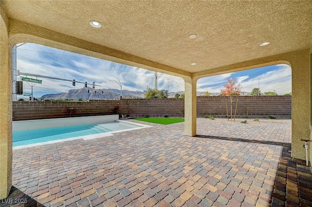 view of swimming pool with a patio and a fenced backyard