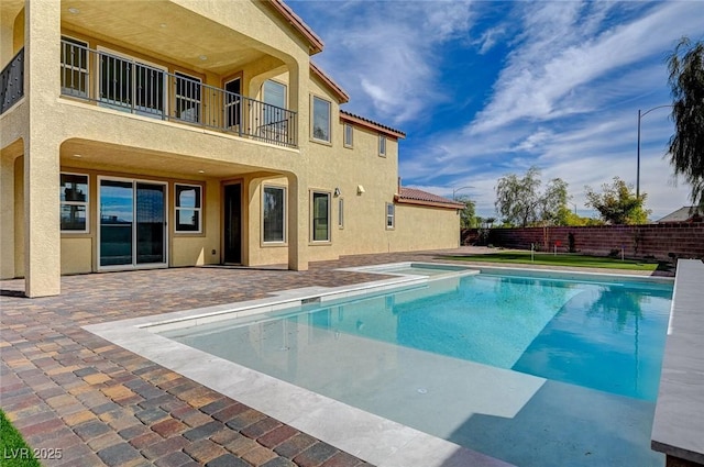 view of swimming pool with a patio area, fence, and a fenced in pool