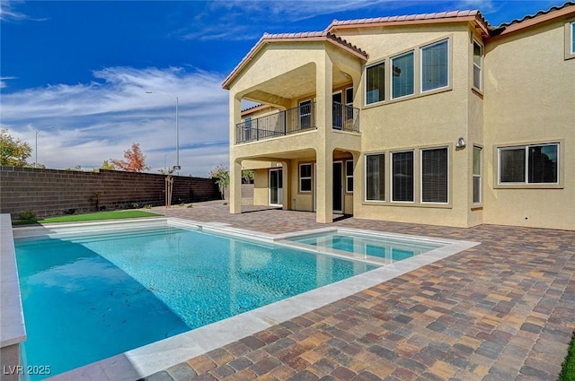 view of pool with a patio area, a fenced backyard, and a pool with connected hot tub