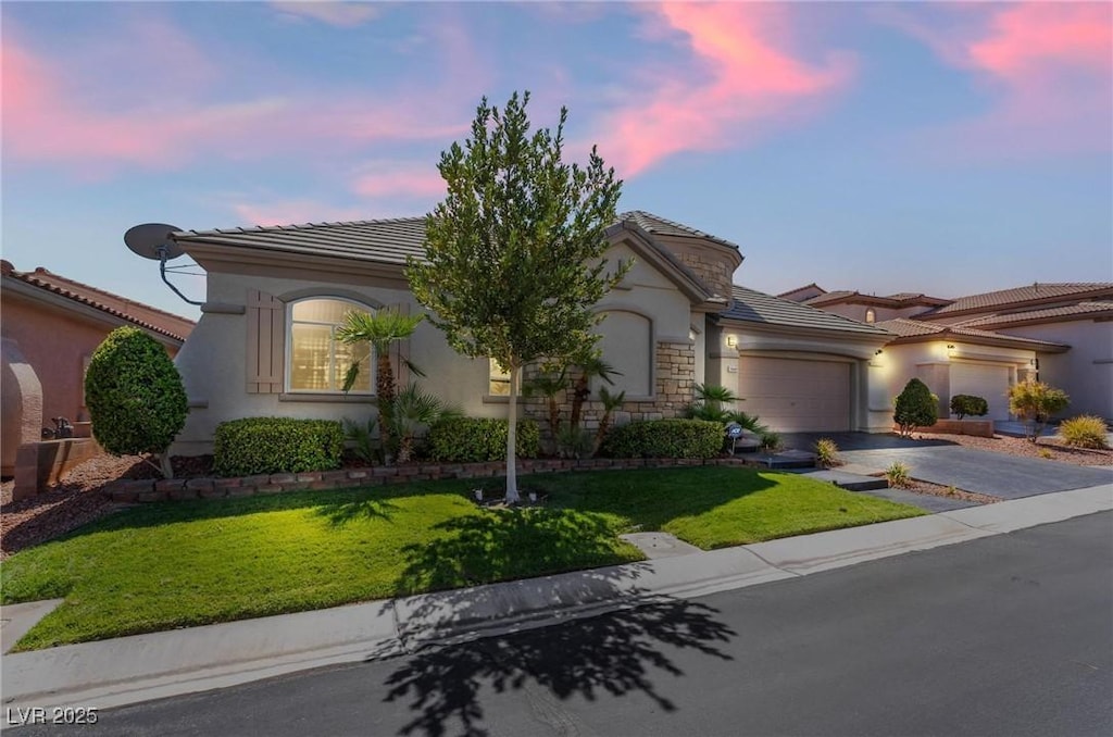 view of front of home with a lawn and a garage