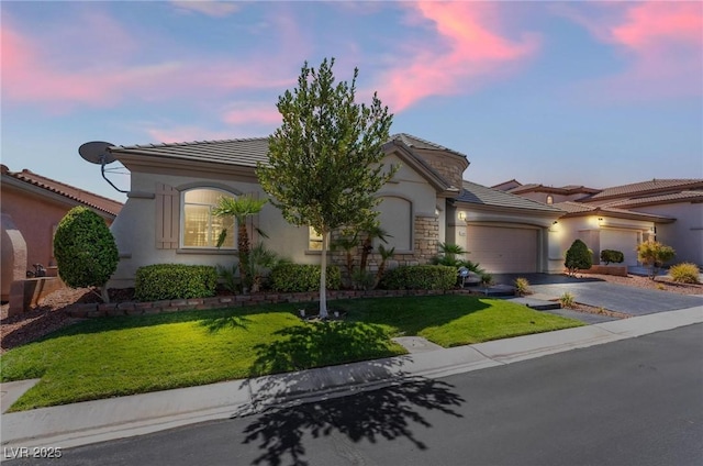 view of front of home with a lawn and a garage