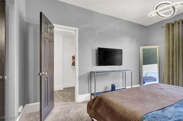 bedroom with light carpet and an inviting chandelier