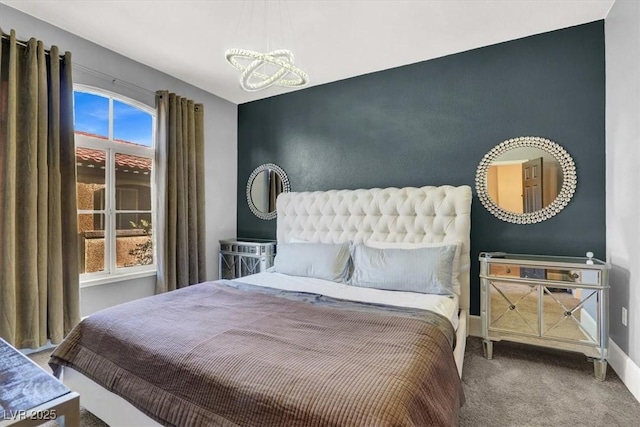 bedroom featuring carpet flooring and an inviting chandelier