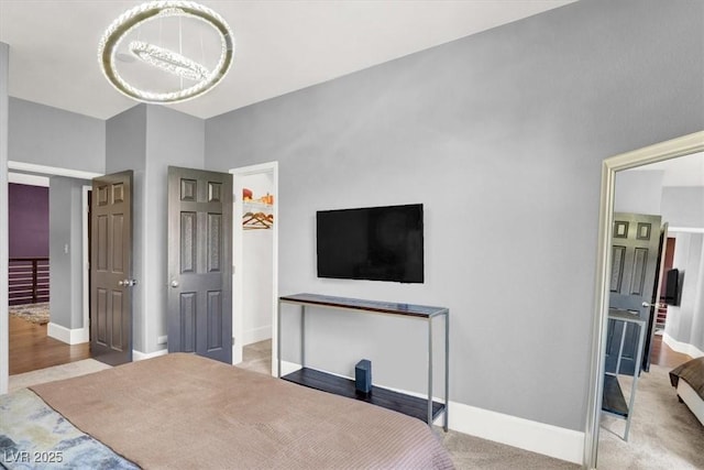 bedroom with light colored carpet and a chandelier