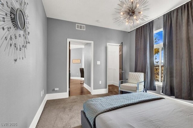 bedroom featuring an inviting chandelier and carpet